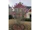 Inviting front yard features blooming Magnolia tree in front of the home at 309 Forest Haven Drive Dr, Holly Springs, NC 27540