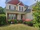 Charming two-story home with a beautifully landscaped front yard and inviting covered porch at 309 Forest Haven Drive Dr, Holly Springs, NC 27540