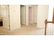 Hallway with neutral carpet leads to various rooms with doors and white trim, creating a bright and inviting space at 309 Forest Haven Drive Dr, Holly Springs, NC 27540