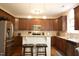 Modern kitchen with stainless steel appliances, dark wood cabinets, and granite countertops at 309 Forest Haven Drive Dr, Holly Springs, NC 27540