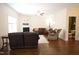 Inviting living room with a cozy fireplace and comfortable leather sectional sofa at 309 Forest Haven Drive Dr, Holly Springs, NC 27540