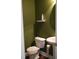 Powder room features a neutral toilet and sink against green walls, creating a functional and convenient space at 309 Forest Haven Drive Dr, Holly Springs, NC 27540