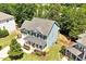 Aerial view of a charming home featuring a landscaped yard and inviting front porch at 309 Larkhaven Pl, Apex, NC 27539