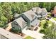 Aerial shot of a beautiful home showcasing the lush landscaping, a sprawling lawn and a two-car garage at 309 Larkhaven Pl, Apex, NC 27539