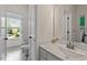 Bright bathroom featuring a neutral color scheme, window, and a tiled floor at 309 Larkhaven Pl, Apex, NC 27539