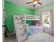 Bright bedroom with a bunk bed, stairs with drawers, and a large window at 309 Larkhaven Pl, Apex, NC 27539
