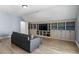 Inviting bonus room featuring built-in shelving and cabinets with a comfortable couch at 309 Larkhaven Pl, Apex, NC 27539