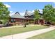Clubhouse exterior featuring lush green lawn, brick accents, and inviting entrance at 309 Larkhaven Pl, Apex, NC 27539