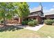 Charming clubhouse exterior with lush landscaping, brick accents, and convenient walkway at 309 Larkhaven Pl, Apex, NC 27539