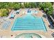 The community pool offers a lap area, splash pad, sun loungers, and shaded seating areas at 309 Larkhaven Pl, Apex, NC 27539