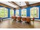 Stately dining room with hardwood floors, chandelier, and large windows at 309 Larkhaven Pl, Apex, NC 27539
