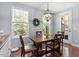 Charming dining room featuring natural light, hardwood floors, and access to a screened-in porch at 309 Larkhaven Pl, Apex, NC 27539