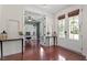 Inviting entryway featuring hardwood floors, natural light, and french doors leading to the office space at 309 Larkhaven Pl, Apex, NC 27539