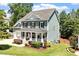 Charming two-story home with a welcoming front porch and landscaped yard provides inviting curb appeal at 309 Larkhaven Pl, Apex, NC 27539