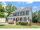 Charming two-story home with a welcoming front porch and landscaped yard provides inviting curb appeal at 309 Larkhaven Pl, Apex, NC 27539