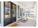 Charming front porch with rocking chair and double doors, creating a welcoming entry at 309 Larkhaven Pl, Apex, NC 27539