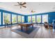 Fun game room featuring a pool table, ceiling fans and large windows with natural light at 309 Larkhaven Pl, Apex, NC 27539