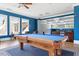 Spacious game room with a pool table, a wet bar and comfortable seating area perfect for entertaining guests at 309 Larkhaven Pl, Apex, NC 27539