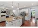 Open-concept kitchen flowing into the living room features granite counters, stainless appliances, and hardwood floors at 309 Larkhaven Pl, Apex, NC 27539