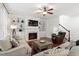 Welcoming living room with a fireplace, built-in shelves, hardwood floors, and access to stairs at 309 Larkhaven Pl, Apex, NC 27539
