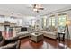 Open-concept living room features hardwood floors, lots of natural light, and adjoins the kitchen at 309 Larkhaven Pl, Apex, NC 27539