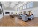 Large lounge area offers seating, tables, high ceilings, large windows and hardwood floors at 309 Larkhaven Pl, Apex, NC 27539