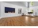 Bright lounge area features hardwood floors, large windows, piano, and white walls at 309 Larkhaven Pl, Apex, NC 27539