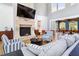 Inviting lounge with fireplace, sofas, high ceilings, and plenty of natural light at 309 Larkhaven Pl, Apex, NC 27539