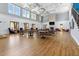 Spacious community lounge with multiple tables, chairs, fireplace and large windows at 309 Larkhaven Pl, Apex, NC 27539