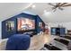 This media room features tiered seating, a large screen, ceiling fan and fun movie decor at 309 Larkhaven Pl, Apex, NC 27539