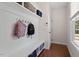 Convenient mudroom featuring hooks, a bench, and natural light from a window at 309 Larkhaven Pl, Apex, NC 27539
