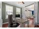 Comfortable home office featuring hardwood floors, natural light, and a neutral color palette at 309 Larkhaven Pl, Apex, NC 27539