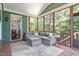 Cozy screened-in porch with comfortable seating, wood floors, and natural light at 309 Larkhaven Pl, Apex, NC 27539