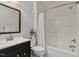 Bright bathroom with a white shower-tub combo and a sleek dark vanity at 309 Plank Bridge Way, Morrisville, NC 27560