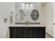 Bathroom featuring a double sink vanity with granite countertop and two oval mirrors at 309 Plank Bridge Way, Morrisville, NC 27560