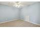 An empty bedroom with blue walls, beige carpet, and a ceiling fan at 309 Plank Bridge Way, Morrisville, NC 27560