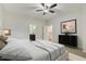 Bright bedroom with white walls and ceiling fan features connecting door to the bathroom and closet at 309 Plank Bridge Way, Morrisville, NC 27560