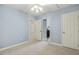 Carpeted bedroom with open doors to an en-suite bathroom and closet at 309 Plank Bridge Way, Morrisville, NC 27560