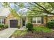 Home with stone facade, a two-car garage, and mature landscaping for curb appeal at 309 Plank Bridge Way, Morrisville, NC 27560