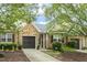 Charming home featuring a stone facade, a two-car garage, and lush landscaping at 309 Plank Bridge Way, Morrisville, NC 27560