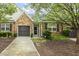 Attractive house with stone facade, well-kept landscaping, and a two-car garage at 309 Plank Bridge Way, Morrisville, NC 27560