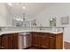 Well-equipped kitchen with stainless steel dishwasher and warm wood cabinetry at 309 Plank Bridge Way, Morrisville, NC 27560