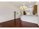 Spacious living area featuring hardwood floors, an open staircase, and access to the dining area at 309 Plank Bridge Way, Morrisville, NC 27560