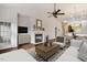 Cozy living room with open floor plan, a fireplace, and modern furniture, perfect for entertaining guests at 309 Plank Bridge Way, Morrisville, NC 27560