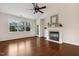 Bright living room featuring hardwood floors, a fireplace, and large windows overlooking the landscape at 309 Plank Bridge Way, Morrisville, NC 27560