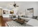 Cozy living room with vaulted ceiling, ceiling fan, and a partial view of the open concept dining area at 309 Plank Bridge Way, Morrisville, NC 27560