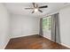 An airy bedroom with a ceiling fan, window, and wood-look flooring at 310 Bay Dr, Cary, NC 27511