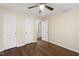 Bedroom boasts hardwood floors, a ceiling fan, and multiple doors for easy access and storage at 310 Bay Dr, Cary, NC 27511