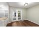 Open dining area with hardwood floors and double doors to the backyard patio at 310 Bay Dr, Cary, NC 27511