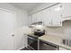 A view of the kitchen showcasing an electric range, dishwasher and overhead cabinets at 310 Bay Dr, Cary, NC 27511